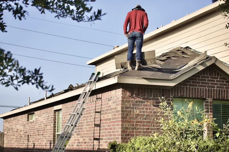 Professional roofer working on a residential roof in Shainline